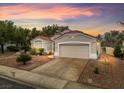 A cozy one-story home boasts a desert landscaped front yard and a convenient two-car garage at 2008 Hobbyhorse Ave, Henderson, NV 89012