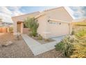 Attractive single-story home featuring a two-car garage, desert landscaping, and a covered front entry at 2147 Indigo Creek Ave, Henderson, NV 89012