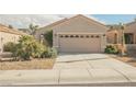 Inviting single-story home with a two-car garage, desert landscaping, and a well-maintained front yard at 2147 Indigo Creek Ave, Henderson, NV 89012