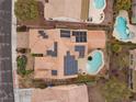 Aerial view of a home with a private pool and solar panels on the roof at 2151 Bannerwood St, Henderson, NV 89044