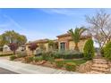 Single story home boasting mature landscaping, a tile roof, and a well manicured front yard on a sunny day at 2151 Bannerwood St, Henderson, NV 89044