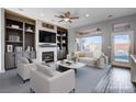 Inviting living room features custom built-ins, a fireplace, and large windows with a view at 3012 Anna Bay Dr, Las Vegas, NV 89134