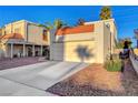 Exterior shot of charming stucco home featuring a driveway and attached garage with a red tile roof at 3152 Centavo Dr, Las Vegas, NV 89117