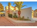 Exterior shot of charming home featuring desert landscaping, decorative rock, and a mature palm tree at 3152 Centavo Dr, Las Vegas, NV 89117