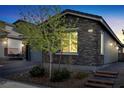 Charming home with stone accents, a manicured front yard and stone steps to front entry at 3155 Mossfield Ave, Henderson, NV 89052