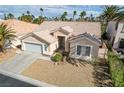 Inviting single-story home featuring desert landscaping, two-car garage, and desert landscaping at 33 Chateau Whistler Ct, Las Vegas, NV 89148