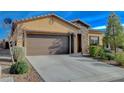 Inviting single-story home with a desert-style front yard, a two-car garage, and a sunny sky overhead at 4459 S Glory Vine Ln, Pahrump, NV 89061