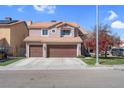 Charming two-story home with a three-car garage, tile roof, and well-maintained landscaping at 4647 Stearman Dr, North Las Vegas, NV 89031