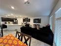 Bright living space features a modern kitchen with an island and black sofa for relaxing at 4924 Chidlaw Ave # 3, Las Vegas, NV 89115