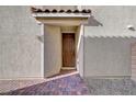 Inviting front door with brickwork and minimalist modern covered entrance at 5040 Serene Skies St, Las Vegas, NV 89130