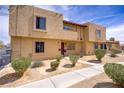 Close-up of a two-story building featuring a desert landscape and pathway at 5706 W Lake Mead Blvd, Las Vegas, NV 89108