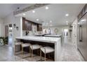 Spacious kitchen features an island with breakfast bar seating, modern appliances, and ample counter space at 5870 N Durango Dr, Las Vegas, NV 89149
