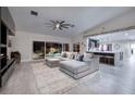 Open-concept living room showcases a large sectional, fireplace, and seamless flow to the kitchen and backyard at 5870 N Durango Dr, Las Vegas, NV 89149