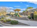 Community playground with slides, palm trees and shade at 6110 Scarlet Leaf St, Las Vegas, NV 89148