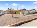 Cozy single-Gathering home with rock landscaping, mature trees, and a two-car attached garage at 6117 Borden Cir, Las Vegas, NV 89107
