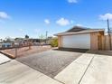 Property showing a driveway with a brick accent that leads to an attached two car garage at 6117 Borden Cir, Las Vegas, NV 89107