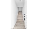 Inviting entryway with wood-look floors leading up to the main level of the home at 6329 Sandy Ridge St # 1, North Las Vegas, NV 89081
