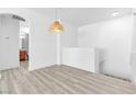 Stylish loft space with wood-look floors and modern lighting fixtures at 6329 Sandy Ridge St # 1, North Las Vegas, NV 89081