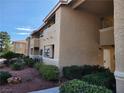 View of condo building featuring manicured landscaping and clearly marked unit numbers at 7200 Pirates Cove Rd # 1014, Las Vegas, NV 89145