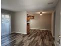 Bright living space with wood-look flooring, dining area, and sliding glass doors at 7200 Pirates Cove Rd # 1014, Las Vegas, NV 89145