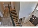 High-ceiling entryway with the staircase to the second floor, boasting wood floors and a modern chandelier at 722 Barrie Ct, Henderson, NV 89002