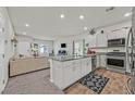 Open-concept kitchen featuring a kitchen island, granite countertops, and stainless steel appliances at 7456 Cooks Meadow St, North Las Vegas, NV 89084