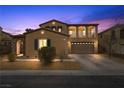 Inviting two-story home with a well-manicured front yard and attached two-car garage at dusk at 7825 Alameda Creek St, Las Vegas, NV 89113