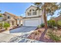 Inviting two-story home with a two-car garage and mature trees at 92 Sea Holly Way, Henderson, NV 89074