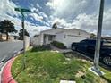 Single-story home with a well-maintained front yard and a two-car garage at , Las Vegas, NV 89106