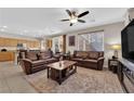 Open-concept living room with tile floors and a ceiling fan at 10457 Raining Sky St, Las Vegas, NV 89178