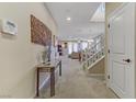 Inviting entryway featuring neutral colors, a staircase, and access to the living and dining areas at 1053 Hickory Park St, Las Vegas, NV 89138