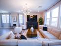 Spacious living room featuring modern lighting, a cozy sofa, and large windows for natural light at 1122 Brilliant Meadow Ave, North Las Vegas, NV 89086