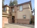 Two-story home with a desert-toned exterior and a well-maintained front yard showcasing curb appeal at 1463 Evening Song Ave, Henderson, NV 89012