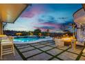 Resort-style backyard with sparkling pool, spa, fire pit, and outdoor seating for relaxing evenings at 19 Isleworth Dr, Henderson, NV 89052