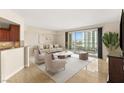 Bright living room with comfortable seating and a sliding glass door to a balcony with city views at 2777 Paradise Rd # 1208, Las Vegas, NV 89109