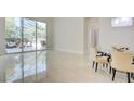 Bright living area with sleek tile flooring, glass doors, and stylish patio furniture visible outside at 2877 Paradise Rd # 104, Las Vegas, NV 89109