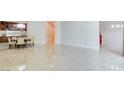 Bright open-plan room with high-gloss tile flooring that flows throughout the living space at 2877 Paradise Rd # 104, Las Vegas, NV 89109