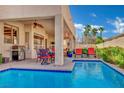 Inviting covered patio and pool with blue skies perfect for relaxing and entertaining at 296 Brushy Creek Ave, Las Vegas, NV 89148