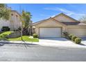 Inviting single-story home with a three-car garage and manicured lawn at 3097 Quail Crest Ave, Henderson, NV 89052