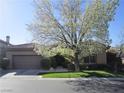 Charming single-story home featuring a well-manicured front yard and a two-car garage at 32 Feather Sound Dr, Henderson, NV 89052