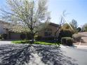Charming single-story home featuring a well-manicured front yard and a two-car garage at 32 Feather Sound Dr, Henderson, NV 89052
