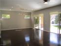 Spacious living room featuring hardwood floors, recessed lighting, and sliding glass doors to the backyard at 32 Feather Sound Dr, Henderson, NV 89052