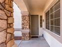 Inviting front entryway features a stone column and a neutral-colored front door at 3305 Alcudia Bay Ave, Las Vegas, NV 89141