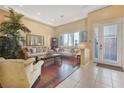 Comfortable living room with hardwood accent flooring, large windows, and elegant furnishings at 3365 Badura Ave, Las Vegas, NV 89118