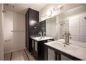 Modern bathroom featuring dual sinks, tile floor, and a walk-in shower at 3369 Milenko Dr, Las Vegas, NV 89121