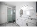 Renovated bathroom with double sinks, marble countertop, and glass-enclosed shower at 3369 Milenko Dr, Las Vegas, NV 89121