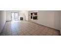 Bright living room with tiled floors, fireplace, and sliding door access to patio at 3369 Milenko Dr, Las Vegas, NV 89121