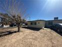 Modest single-story home with a lawn featuring a leafless tree in the front yard at 3709 Perliter Ave, North Las Vegas, NV 89030