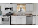 Close up of the stainless steel oven, dishwasher, and granite countertop in the kitchen at 3709 Perliter Ave, North Las Vegas, NV 89030