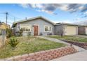 Cozy house featuring a well-kept lawn and garden with a charming walkway leading to the front door at 4102 Calimesa St, Las Vegas, NV 89115